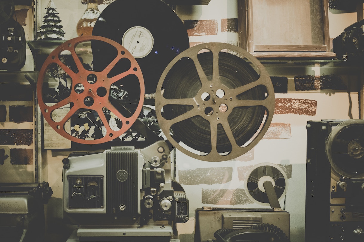 Two film reels against a patterned background