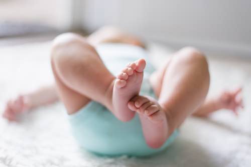 Blurred image of infant feet.