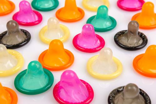 multicolored condoms aligned on a table
