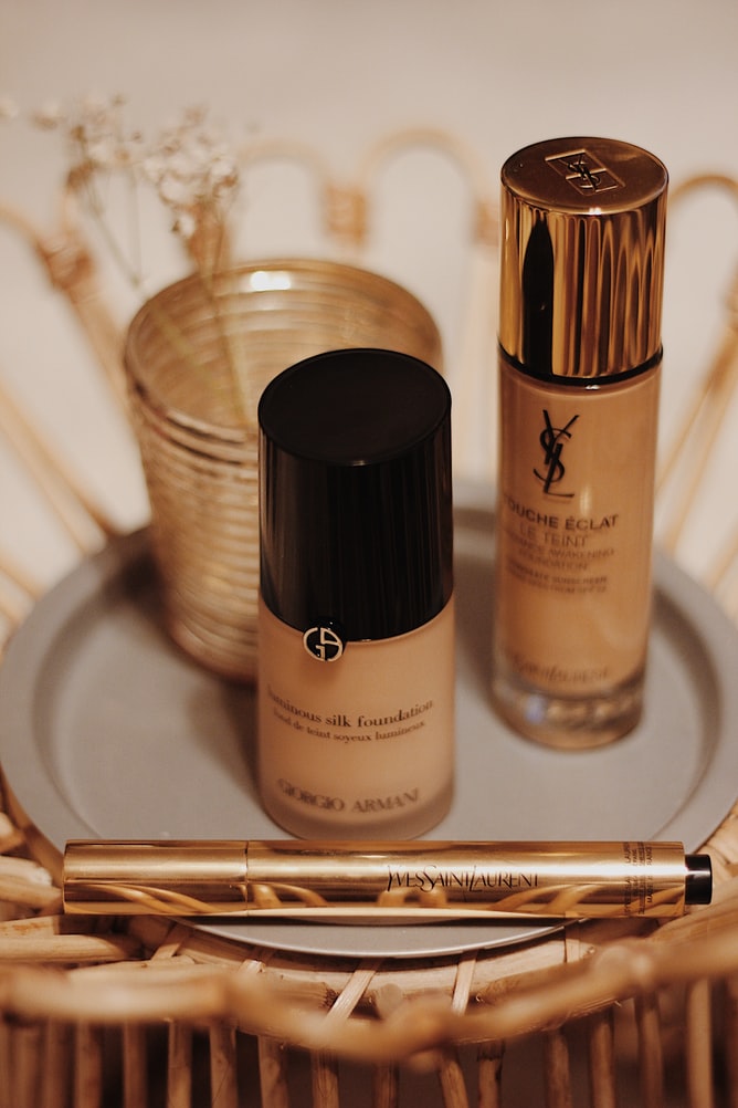 Several small bottles of light brown foundation makeup on a small tray
